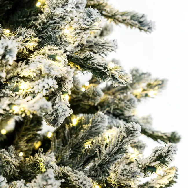 7.5 ft pre-lit flocked Christmas tree with 700 warm white LED lights
